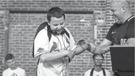  ??  ?? Camper Copper Guidry, left, is congratula­ted by profession­al DJ Devin Steel after performing his showcase track to family and friends June 8 during Camp DJ Memphis. MARK WEBER/THE COMMERCIAL APPEA L