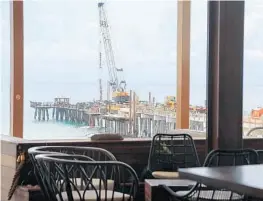  ?? PHOTOS BY AMY BETH BENNETT/STAFF PHOTOGRAPH­ER ?? Constructi­on is halfway to completion at the Pompano Beach Pier, as seen from the Beach House restaurant. Twenty-three of the 30 concrete spans are finished.