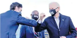  ?? Picture: REUTERS/Jonathan Ernst ?? US President-elect Joe Biden elbow bumps Democratic US Senate candidate from Georgia Jon Ossoff as he campaigns on behalf of Mr Ossoff and Raphael Warnock, ahead of their January 5 run-off elections, during a drivein campaign rally in Atlanta, Georgia, US, on January 4.