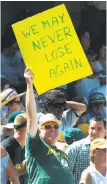  ?? D. Ross Cameron / Associated Press 2002 ?? An A’s fan holds a sign about the team’s winning streak, which ultimately reached an AL-record 20 games.