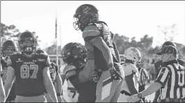  ?? RICHARD SHIRO/AP ?? Coastal Carolina's ReeseWhite, right, is lifted byWillie Lampkin after scoring Saturday.