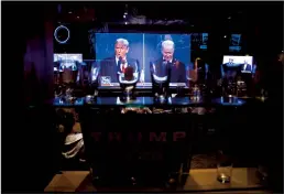  ?? SERGIO FLORES/GETTY IMAGES ?? A TV shows the presidenti­al debate inside a restaurant at a watch party for the final presidenti­al debate between President Donald Trump and former Vice President Joe Biden on Oct. 22 in San Antonio.