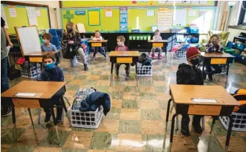  ?? ANTHONY VAZQUEZ/CHICAGO SUN-TIMES ?? Students sit at their desks at Hawthorne Scholastic Academy on Monday.