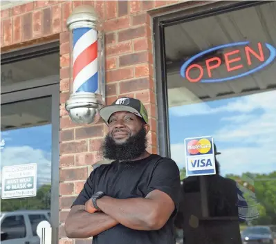  ?? PHOTOS BY ALEX HICKS JR./STAFF ?? Ja Morant of the NBA'S Memphis Grizzlies went to Crestwood High School and grew up near Sumter, S.C. He was the 2nd overall pick in the 2019 NBA Draft behind Zion Williamson. His father, Tee Morant, worked at Precision Cuts Barber Shop in Sumter. On May 7, family and friends of Tee and Ja Morant came to the barber shop. As normal, many came to get a haircut, most talked about what Ja Morant would do in the NBA playoffs. Here, Jesse Wilson, 47, proudly stands outside Precision Cuts wearing his Grizzlies hat to support his friend, Ja Morant.