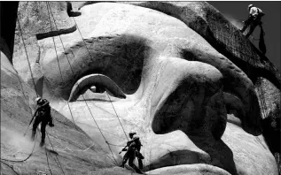  ?? CHARLIE RIEDEL / ASSOCIATED PRESS FILE (2005) ?? Workers use pressure washers to clean around the face of Thomas Jefferson at Mount Rushmore National Memorial on July 22, 2005, in South Dakota.