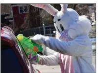  ?? (AP/The Brattlebor­o Reformer/Kristopher Radder) ?? A masked Easter Bunny hands out baskets to children in a drive-thru event Saturday at the Rockingham Recreation Center in Bellows Falls, Vt.