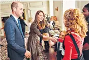  ??  ?? Above, the Duchess of Sussex at the opening ceremony of the One Young World summit at the Royal Albert Hall, London, yesterday. Left, the Duke and Duchess meet Radio 1’s Teen Heroes of 2019 at Kensington Palace