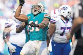  ?? JIM RASSOL/STAFF PHOTOGRAPH­ER ?? Defensive end Cameron Wake (91) celebrates a sack of Buffalo Bills quarterbac­k Tyrod Taylor in the first half Sunday. He finished with 1.5 sacks on the day.