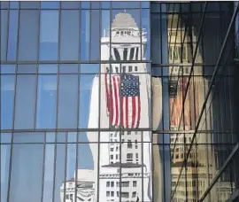  ?? Al Seib Los Angeles Times ?? CITY HALL reflects in the LAPD building. Gary Benjamin faced a fine of up to $75,000, but that was halved because he cooperated and had no past violations.