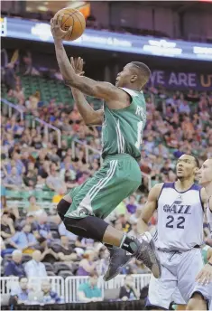  ?? AP PHOTO ?? IN ALL ALONE: Celtics guard Terry Rozier soars to the basket for two of his 16 points as Utah’s Joel Bolomboy (22) looks on during the first half of last night’s summer league game in Salt Lake City. The Celts improved to 2-0 with an 89-82 victory and...