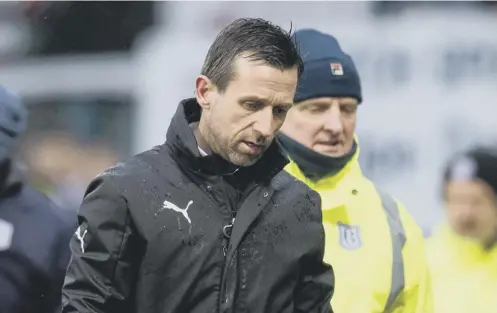  ?? PICTURE: ROSS PARKER/SNS ?? 0 A very unhappy Neil Mccann trudges along the Dens Park track following the altercatio­n at full-time.