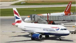  ?? (Denis Balibouse/Reuters) ?? A BRITISH AIRWAYS aircraft parks next to an EasyJet plane at Cointrin airport in Geneva earlier this year.