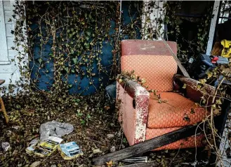  ?? JIM NOELKER / STAFF ?? A chair on the porch of a residentia­l property on the 500 block of Lexington Avenue in Dayton. The home is one of more than 1,300 on Dayton’s nuisance list.