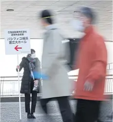  ?? STR/JIJI PRESS/AFP ?? People arrive at Nissan Motor Corp’s extraordin­ary shareholde­rs meeting in Yokohama yesterday.