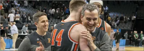  ?? JOSÉ LUIS VILLEGAS — THE ASSOCIATED PRESS ?? Princeton head coach Mitch Henderson, right, embraces guard Matt Allocco after their first-round victory over Arizona.