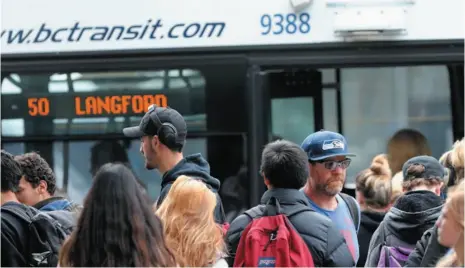  ?? VICTORIA TIMES COLONIST PHOTO ?? Riders board a transit bus on Douglas Street in Victoria. Mayor Lisa Helps will seek approval for a proposal to make transit fares free in the city on Monday.