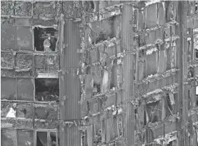  ?? GETTY IMAGES ?? A member of emergency services works on one of the floors of the Grenfell Tower in the aftermath of the deadly fire.