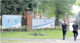  ??  ?? > Police outside RAF Marham in Norfolk yesterday