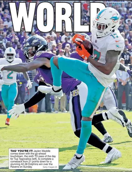  ?? Getty Images (2) ?? TAG’ YOU’RE IT! Jaylen Waddle comes down with the go-ahead touchdown, the sixth TD pass of the day for Tua Tagovailoa (left), to complete a comeback from 21 points down for a stunning 42-38 Dolphins win over the Ravens on Sunday.