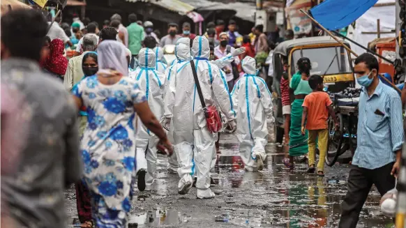  ?? EPA ?? Indian healthcare workers in Mumbai. Medical staff and the over-55s could be prioritise­d when it comes to who first receives a vaccine