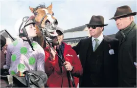  ??  ?? Sealed with a kiss: Jockey David Mullins with Faugheen, owner Rich Ricci (second right) and Willie Mullins, who has a healthy lead in the race for the trainers’ title