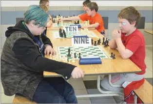  ?? NEWS PHOTOS MO CRANKER ?? Top: Jacob Giroux and Carter Payeur battle in what would become a stalemate match of chess Saturday at Crescent Heights High School.
Left: Kyrina Cole tries to work her way out of a tough chess situation Thursday during a tournament held by the...