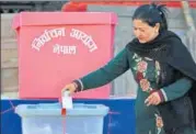  ?? AFP ?? A Nepali voter casts her ballot at a polling station during the final round of parliament­ary elections in Kathmandu on Thursday.