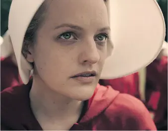  ??  ?? Elisabeth Moss stars in and is a producer of the new television adaptation of Margaret Atwood’s dystopian novel.