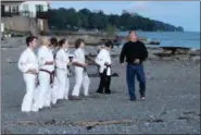  ?? JONATHAN TRESSLER — THE NEWS-HERALD ?? Sanchi-Ryu Karate Master Instructor Richard Fike, proprietor of Madison Combine Martial Arts, encourages back-belt candidates, from left, Josh Dean, Billy Montgomery, Klint Tomlinson, Rio Caya, Ryan Downie and Tyler Cahill during an intense morning...