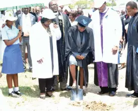  ??  ?? Sizane High School headmistre­ss Reverend Deborah Manyoba digs at the ground breaking ceremony for the constructi­on of a multi-purpose pavillion recently