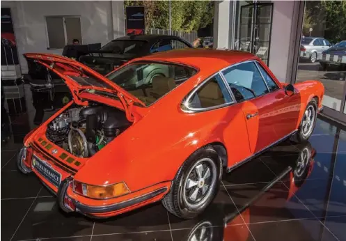  ??  ?? Left: This fabulous 1970 911 2.2E looked resplenden­t in tangerine and had a comprehens­ive history folder, to boot