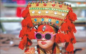  ?? NIRANJAN SHRESTHA / ASSOCIATED PRESS ?? A Nepalese girl dressed as a goddess waits to take part in Kumari Puja at Hanuman Dhoka, Basantapur Durbar Square in Kathmandu, Nepal, on Monday.