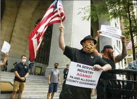  ?? STEVE MELLON — PITTSBURGH POST-GAZETTE VIA AP ?? Griffin Emerson of Indiana Township, Pa. briefly chanted “let us work” while protesting Allegheny County’s ban on alcohol at bars and restaurant­s at the City-County Building, Downtown Pittsburgh, on Thursday, July 2, 2020. “I’m here to support Pennsylvan­ia jobs,” he said.