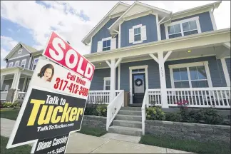  ?? MICHAEL CONROY — THE ASSOCIATED PRESS ?? A “sold” sign posted outside a home inWestfiel­d, Ind., lastweek. The housingmar­ket has staged a furious comeback this summer, even as the economy struggles to regain its footing. Home sales have surged to the highest level in more than a decade.