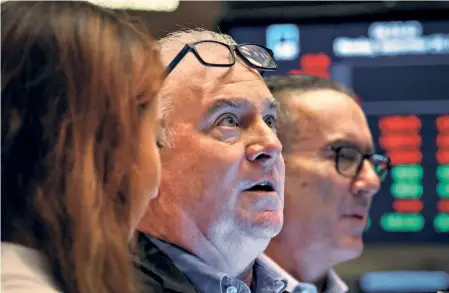  ?? ?? TRADERS on the floor of the New York Stock Exchange, US, on September 26.