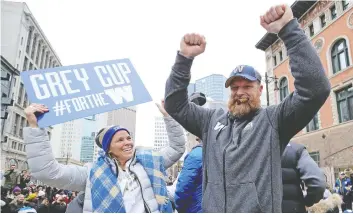  ?? KEVIN KING/POSTMEDIA ?? Blue Bombers head coach Mike O’Shea celebrates during Winnipeg’s Grey Cup parade on Tuesday. O’Shea is now a free agent, but cashing in with a new contract isn’t as easy as it used to be for a title-winning coach thanks to the CFL’s football operations salary cap.