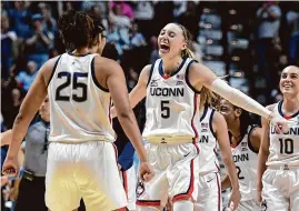  ?? Tyler Sizemore/Hearst Connecticu­t Media ?? UConn’s Paige Bueckers (5) celebrates with Ice Brady after making a 3-pointer against Marquette on Sunday.