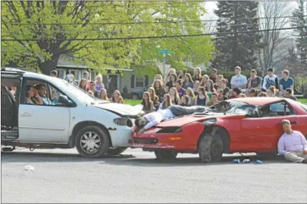  ?? JOHN BREWER - ONEIDA DAILY DISPATCH ?? Oneida High School students, along with the Oneida Police Department, Oneida Fire Department, Vineall Ambulance, Madison County District Attorney, and Campbell-Dean Funeral Home, take part in a mock DWI accident at the Oneida High School on Thursday.