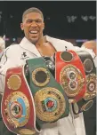  ?? NICK POTTS/PA VIA AP ?? Anthony Joshua celebrates with his belts after victory over Joseph Parker to become the WBA, IBF and WBO heavyweigh­t champion Saturday in Cardiff, Wales.