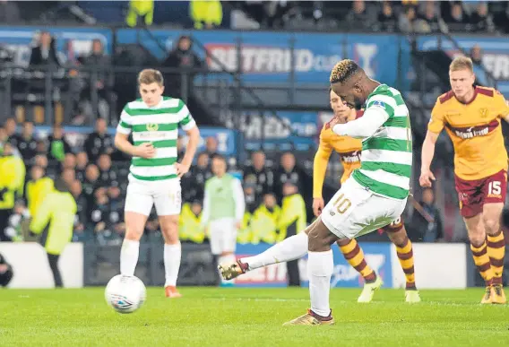  ??  ?? Moussa Dembele, seen above scoring from the spot against Motherwell in the Betfred Cup Final, is fully committed to Celtic says Brendan Rodgers.