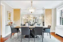  ?? H5 Property ?? An oversized, ornate chandelier adds glamour to this dining room.