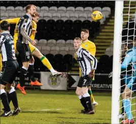  ??  ?? Ryan Porteous rises highest to head home the opener for Hibs