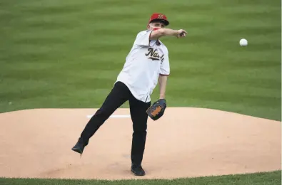  ?? Alex Brandon / Associated Press ?? Dr. Anthony Fauci steps up and delivers a memorable first pitch on Opening Day in the nation’s capital. It did not go well for the director of the National Institute of Allergy and Infectious Diseases, but apparently no one was injured.