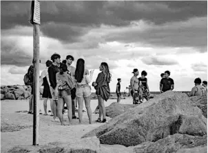  ?? JENNIFER LETT/SUN SENTINEL ?? Young people drink and party at the beach in Fort Lauderdale on Jan. 30.