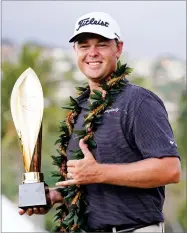  ?? AP PHOTO BY MARCO GARCIA ?? Patton Kizzire holds the Sony Open golf tournament trophy after defeating James Hahn in a six hole playoff, Sunday in Honolulu.