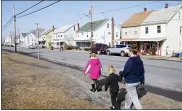  ?? MATT SLOCUM - THE ASSOCIATED PRESS ?? From right, Melissa Weirich, walks with her son, Julien Heim, 4, and daughter, Kacie Thompson, 9, to visit the former home of Kacie’s friend, Ava Lerairo, Thursday, March 11, 2021, in Lansford, Pa. On May 26, 2020, Ava; her mother, Ashley Belson, and Ava’s father, Marc Lerario, were found fatally shot.