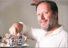  ?? PASCAL POCHARD-CASABIANCA/AFP ?? Frederic Pierrot poses with playmobils depicting Napoleon Bonaparte’s life at the Naporama museum in Corsica.