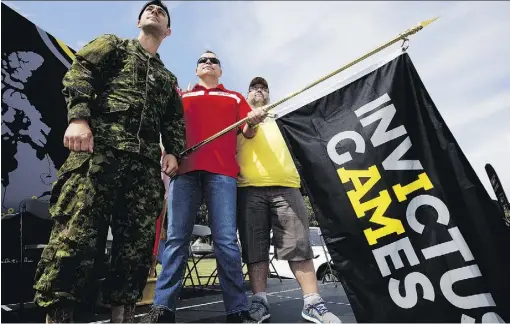  ?? DAVID BLOOM ?? From left, Invictus Games flag bearer Master Cpl. Joel Gagne, competitor Sgt. Lorne Ford and flag bearer Master Warrant Officer (retired) Mark DesRoches take part in the Games flag event at CFB Edmonton on Thursday.