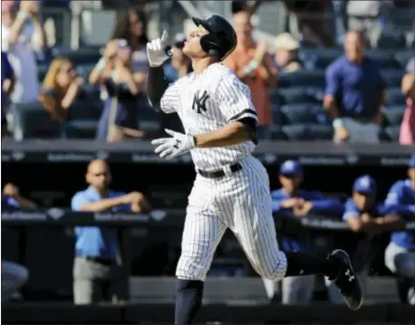  ?? THE ASSOCIATED PRESS ?? Yankees’ Aaron Judge reacts after hitting a solo home run during the seventh inning of Monday’s game. The homer, Judge’s 50th, broke Mark McGwire’s rookie record.