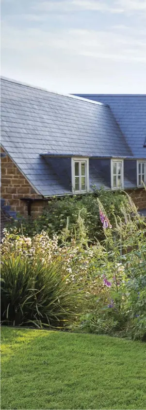  ??  ?? Right The main border, looking towards the back of the house, includes an exuberant mix of Libertia chilensis with its dense clusters of white flowers (far left), the upright Veronicast­rum virginicum ‘Fascinatio­n’ and the Turkish sage Phlomis russeliana.